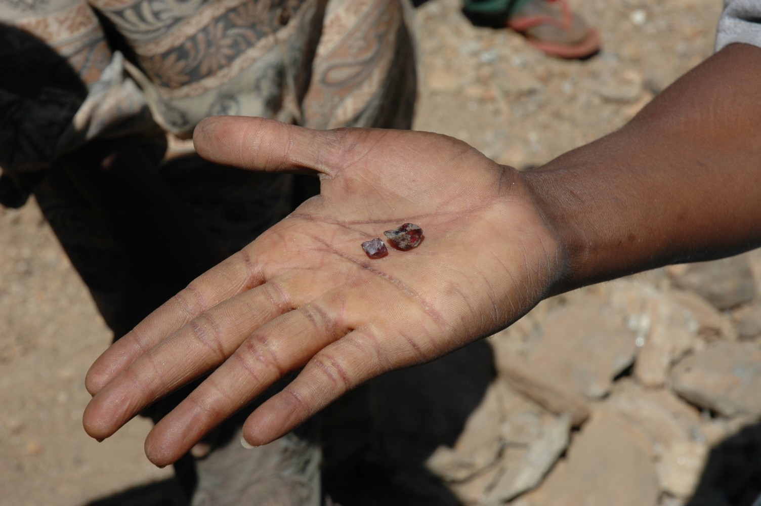 Garnet in miner's hand